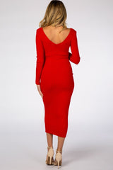 woman wearing a red ribbed maternity dress with a v-back and long sleeves