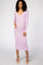 woman wearing a lavender ribbed long sleeve maternity dress and gently holding her baby bump