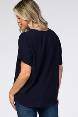 woman wearing a navy blue short sleeve maternity top, viewed from the back