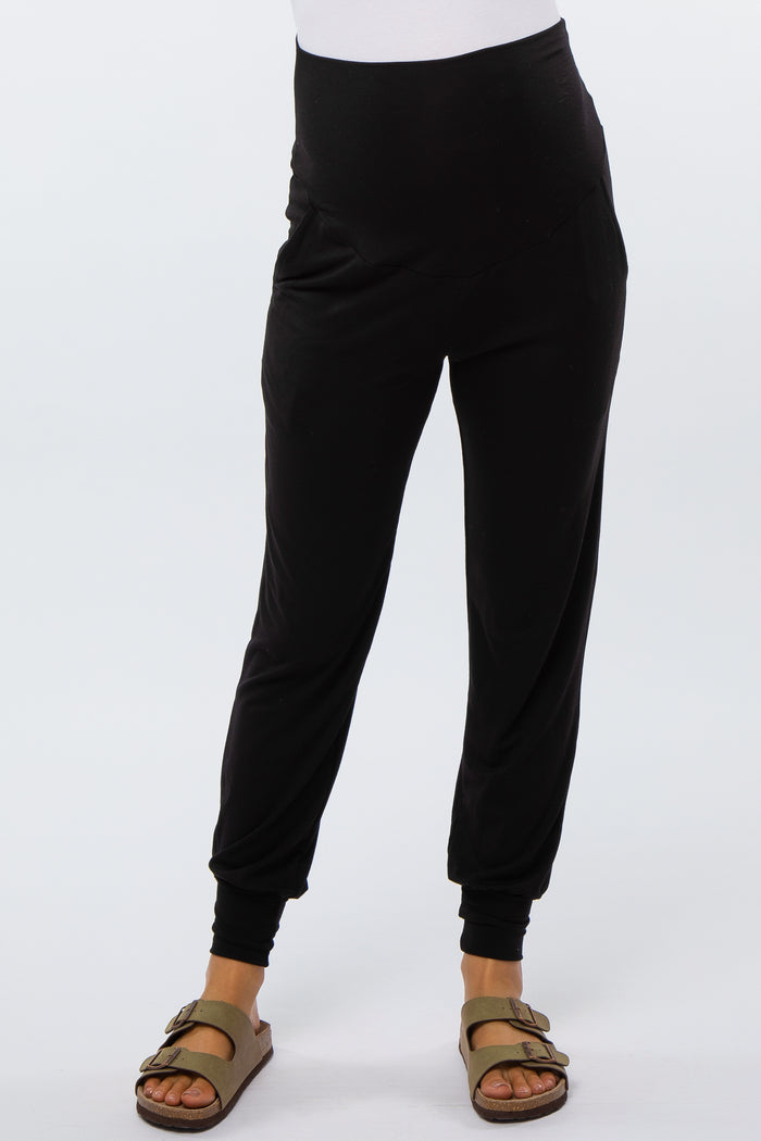 maternity wear black harem-style pants with a high waistband, worn by a model with sandals