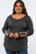woman wearing a dark gray long sleeve plus size top with patterned sleeve details and buttons