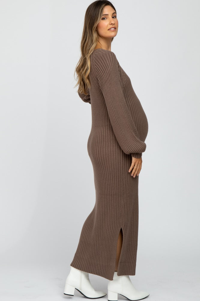 woman wearing a brown ribbed maternity dress with long sleeves and a side slit, showcasing her baby bump