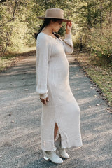 woman wearing a cream ribbed maternity dress with side slits, showcasing her baby bump while walking outdoors