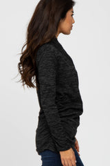 woman wearing a black marled long sleeve top with a relaxed fit and side view showing a casual silhouette