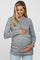 woman wearing a grey wrap-style maternity top and holding her baby bump