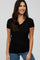 woman wearing a black short sleeve v-neck t-shirt and blue jeans