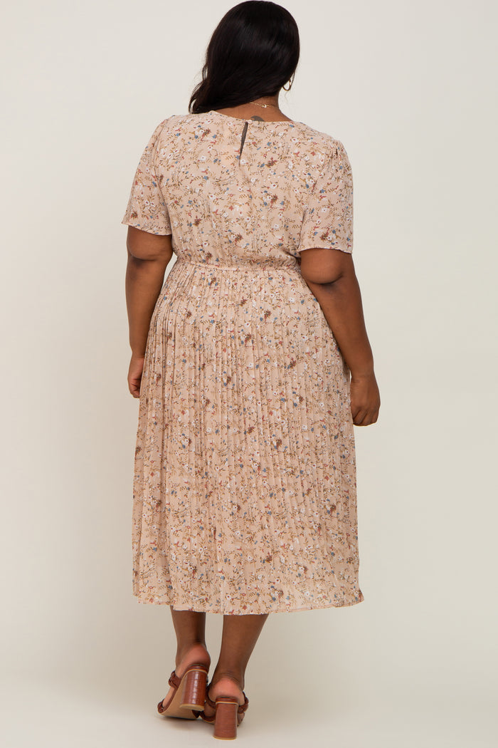woman wearing a light pink floral plus size midi dress with short sleeves and pleated skirt from the back