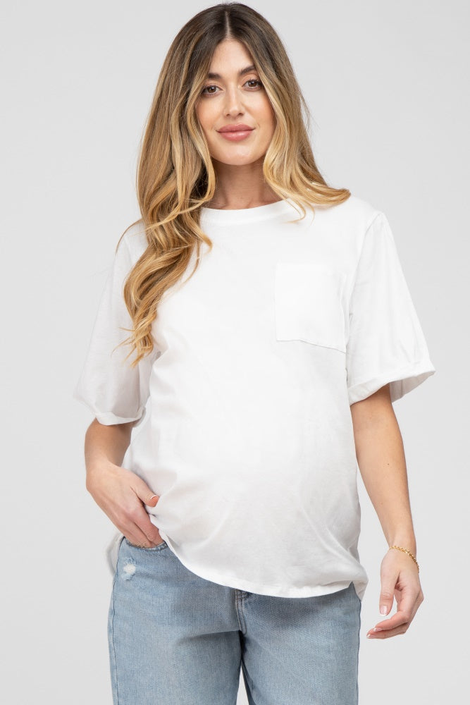 woman wearing a white short sleeve maternity top with a pocket and showing her baby bump