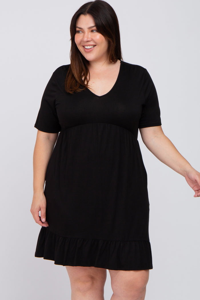 smiling woman wearing a black short sleeve v-neck maternity dress with a ruffled hem