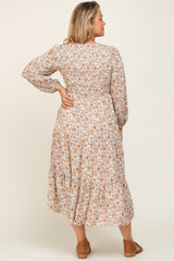 Woman from behind wearing a long sleeve floral smocked midi dress with tiered skirt and brown flats
