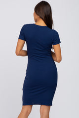 back view of a woman wearing a navy blue short sleeve ribbed bodycon dress