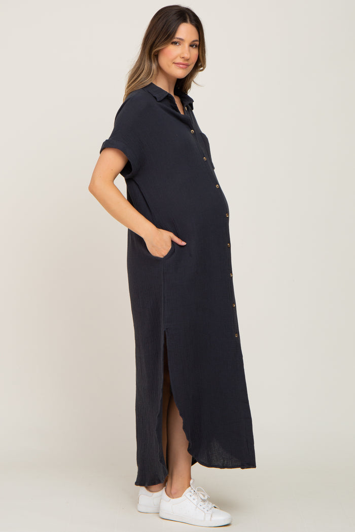 woman wearing a navy blue short sleeve maternity dress with buttons and pockets, featuring a visible baby bump