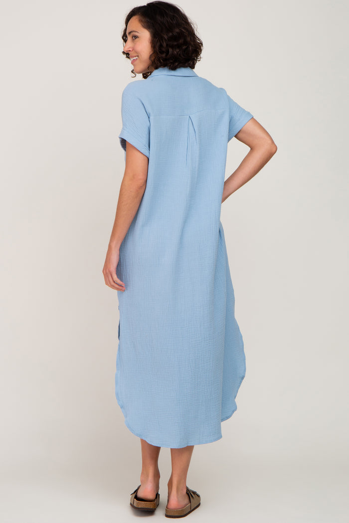 woman wearing a light blue short sleeve midi dress with a relaxed fit and back pleat detail