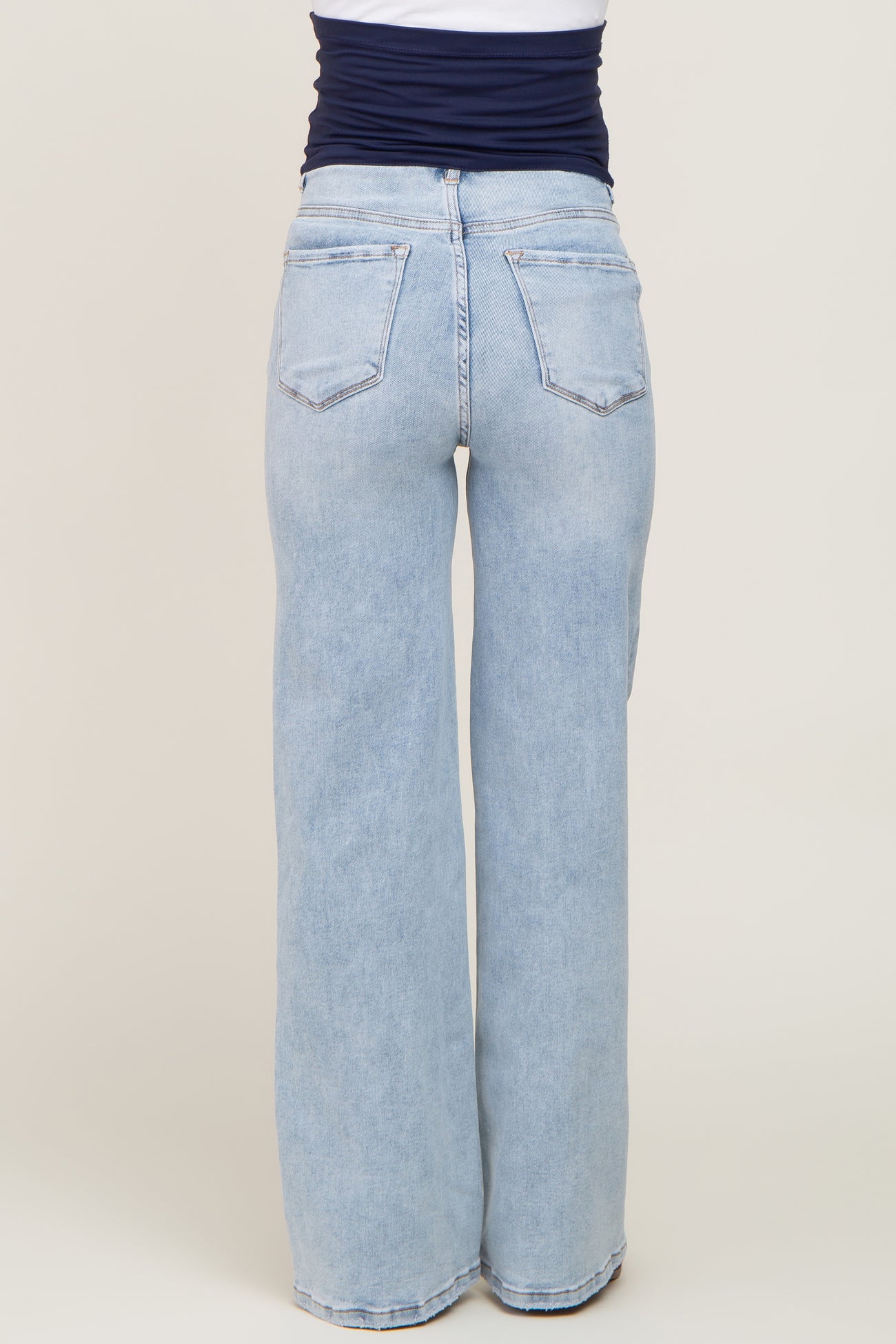 woman wearing light wash maternity wide leg jeans, showing the back view