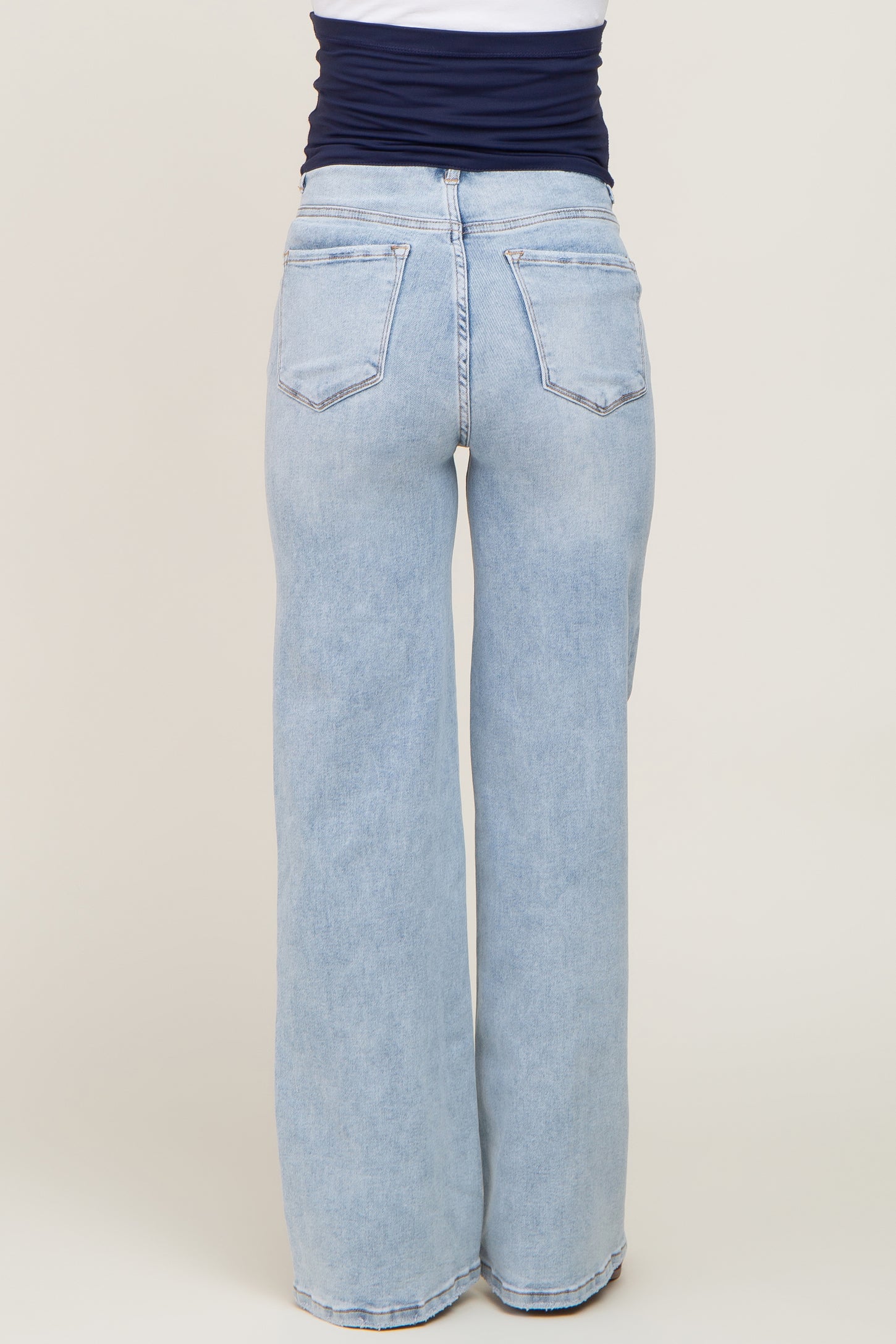 woman wearing light wash maternity wide leg jeans, showing the back view