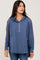 woman wearing a blue hooded pullover with a button placket and front pockets, styled with casual jeans
