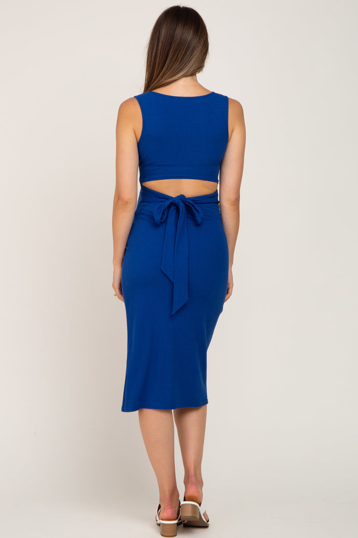 woman wearing a blue ribbed maternity two-piece dress with a fitted crop top and tie detail at the back
