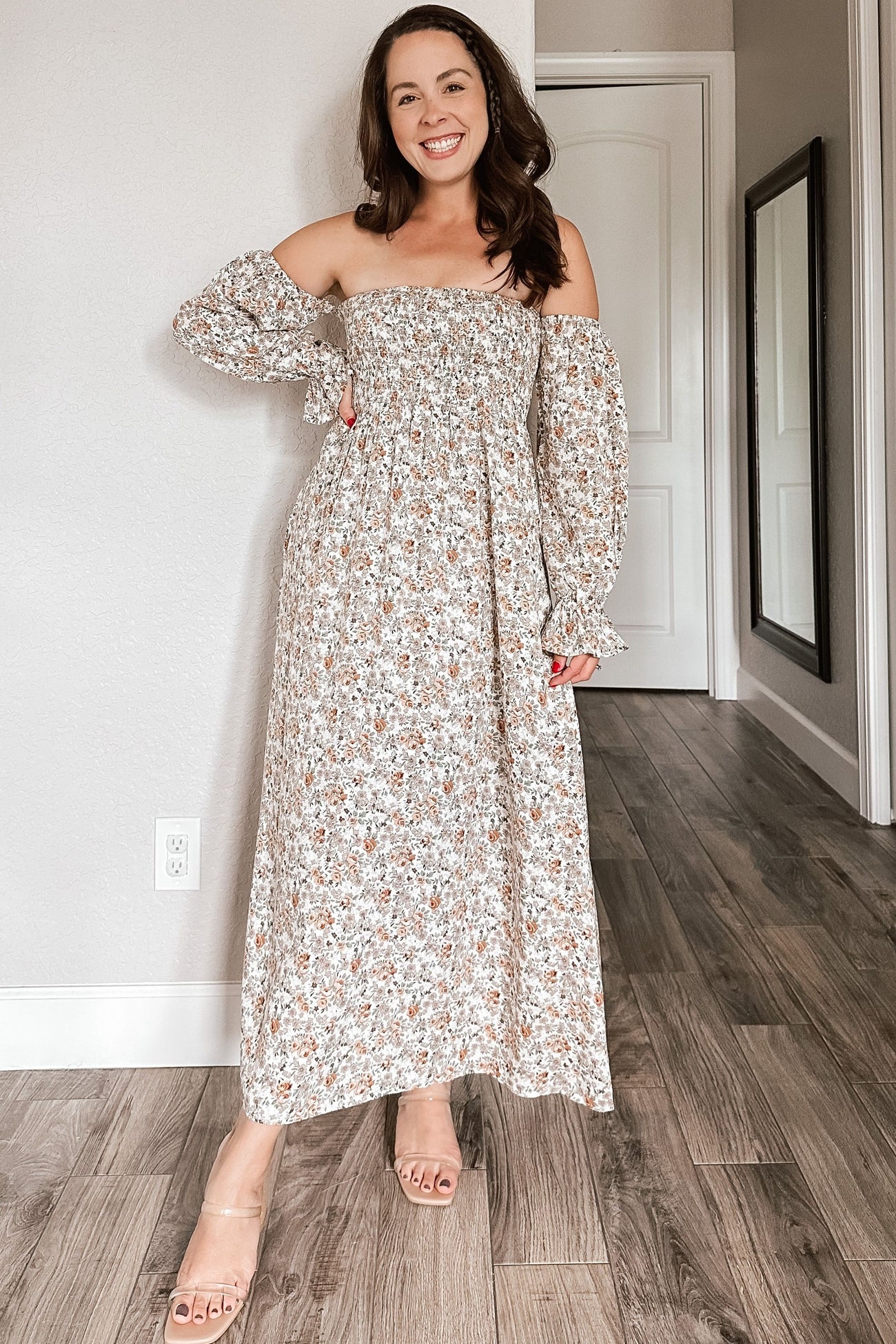 woman wearing a floral off-the-shoulder maxi dress with elastic sleeves and a flowy silhouette