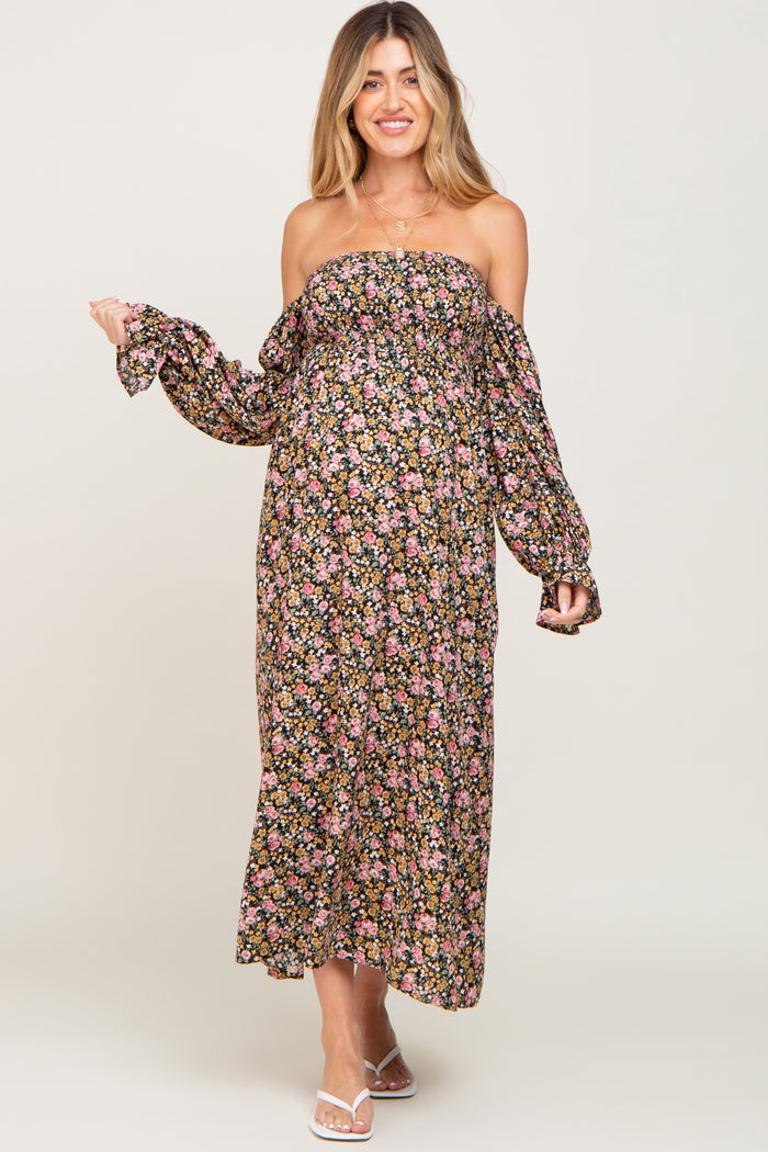 woman wearing a floral off-the-shoulder maxi maternity dress with long sleeves and visible baby bump