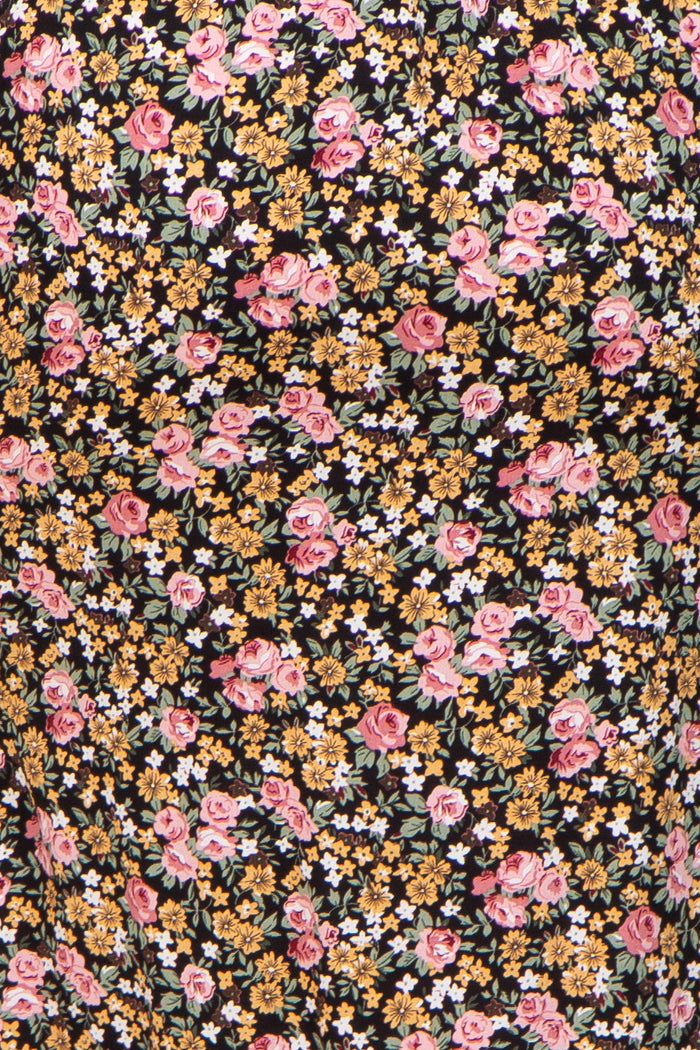 maternity wear in a black fabric with a floral pattern featuring pink roses and yellow flowers