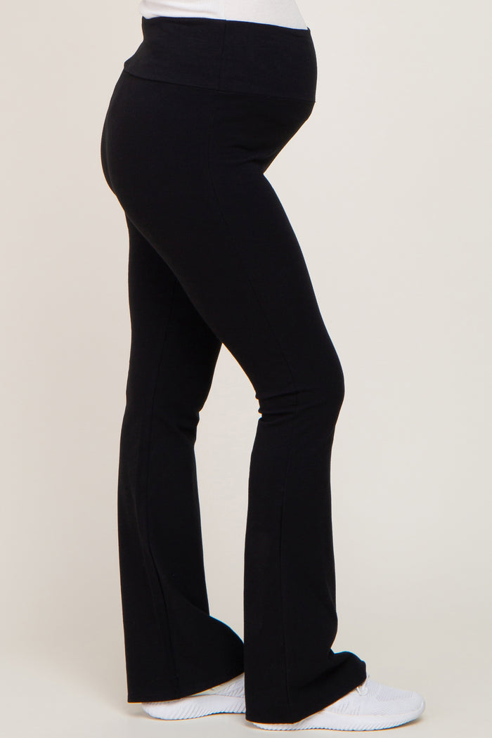woman wearing black maternity flared leggings with a comfortable waistband and visible baby bump
