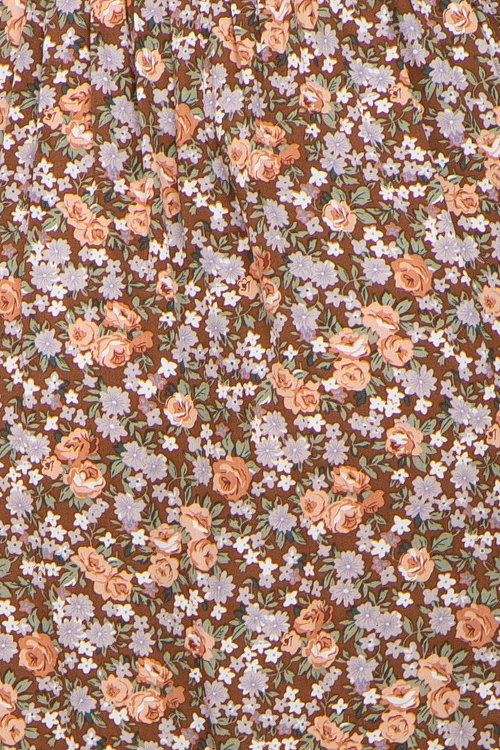 close-up of brown floral print maternity fabric with pink and lavender flowers