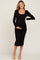 pregnant woman wearing a long sleeve black maternity midi dress with a front tie waist