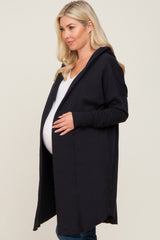 woman wearing a black maternity hoodie cardigan and showing her baby bump