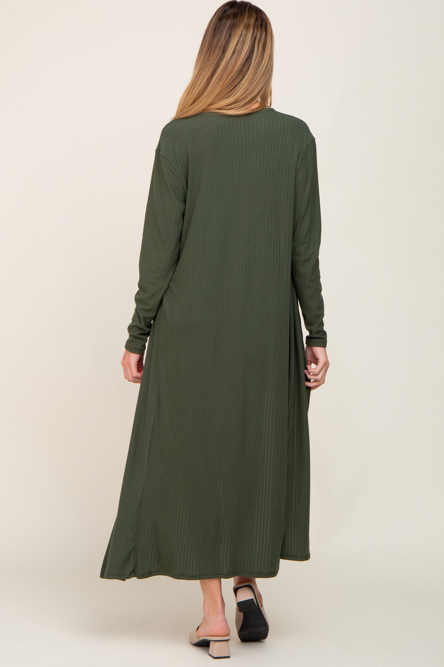 woman wearing a long olive green ribbed maternity dress, shown from the back