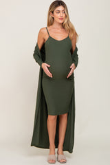woman wearing an olive green maternity dress with a long cardigan, showing her baby bump