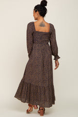 woman wearing a long-sleeve floral maxi dress with a smocked bodice and tiered skirt, seen from the back