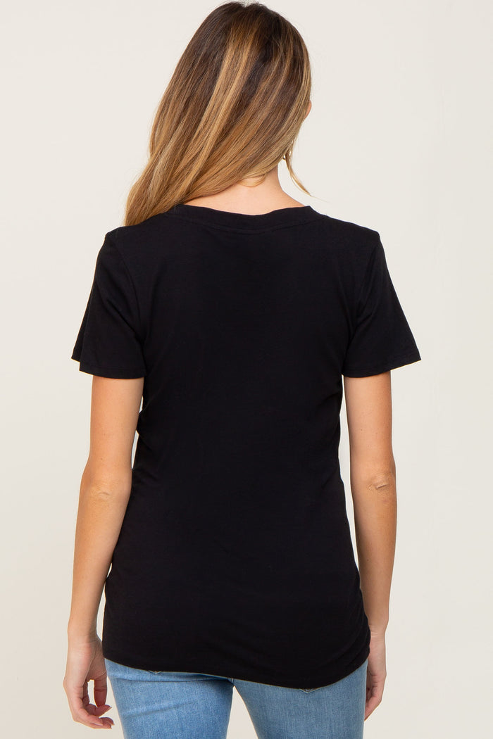 Back view of a woman with long blonde hair wearing a plain black short sleeve t-shirt and blue jeans