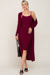 Woman wearing a burgundy ribbed midi dress with a matching long cardigan and black sandals