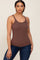 woman wearing a brown ribbed tank top and dark blue jeans