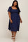 plus size woman wearing a navy blue smocked midi dress with flutter sleeves and white sandals
