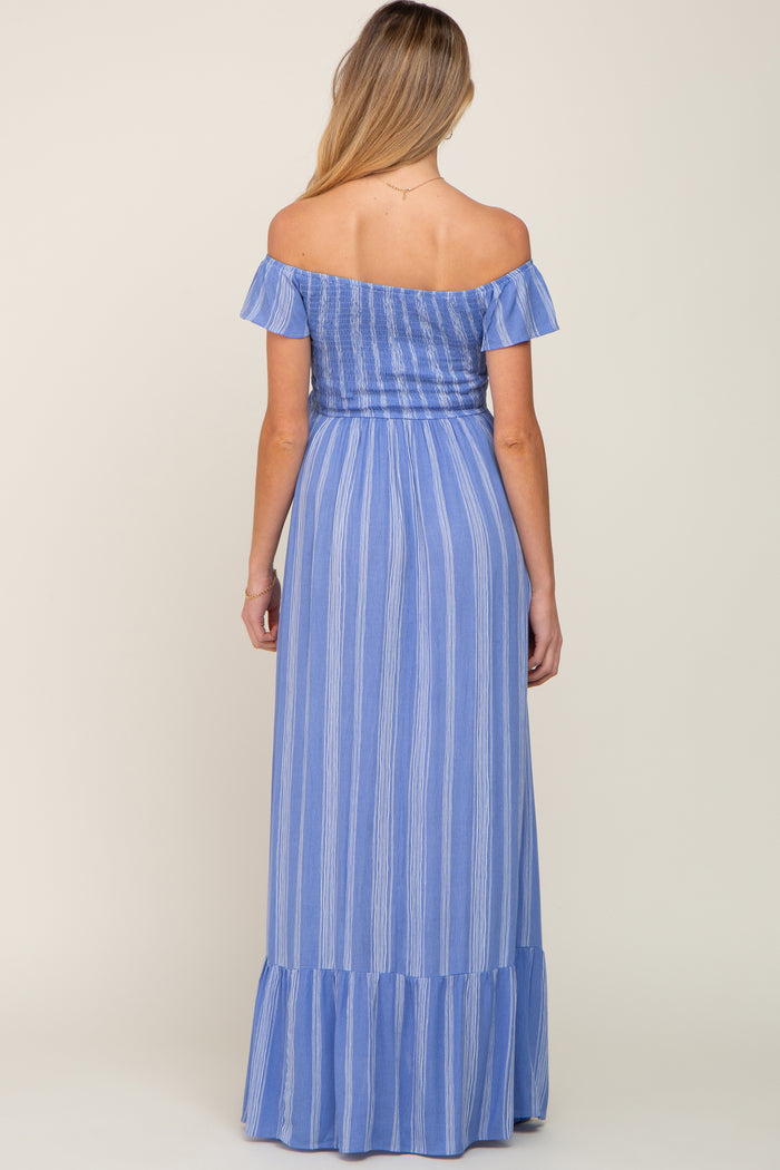 woman wearing a blue striped off-shoulder maternity maxi dress with a ruffled hem and flowing silhouette