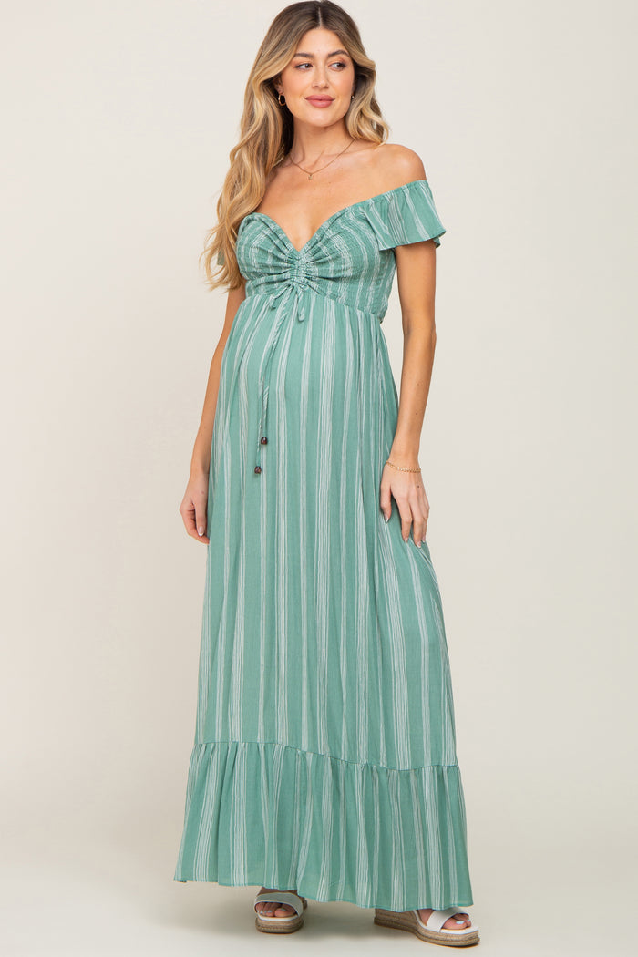 woman wearing a green striped off-the-shoulder maternity maxi dress with a baby bump and tiered bottom
