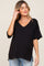 woman wearing a black maternity top with a v-neck and short sleeves, featuring a pocket and side slits
