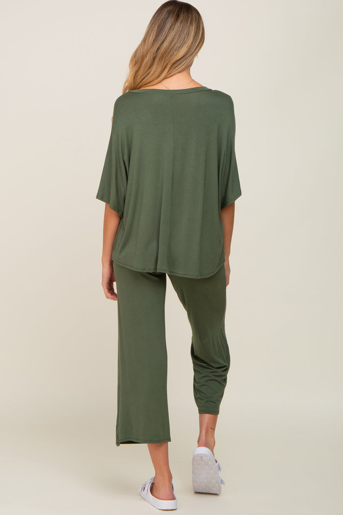 woman wearing an olive green maternity lounge set with wide sleeves and loose pants, model seen from the back