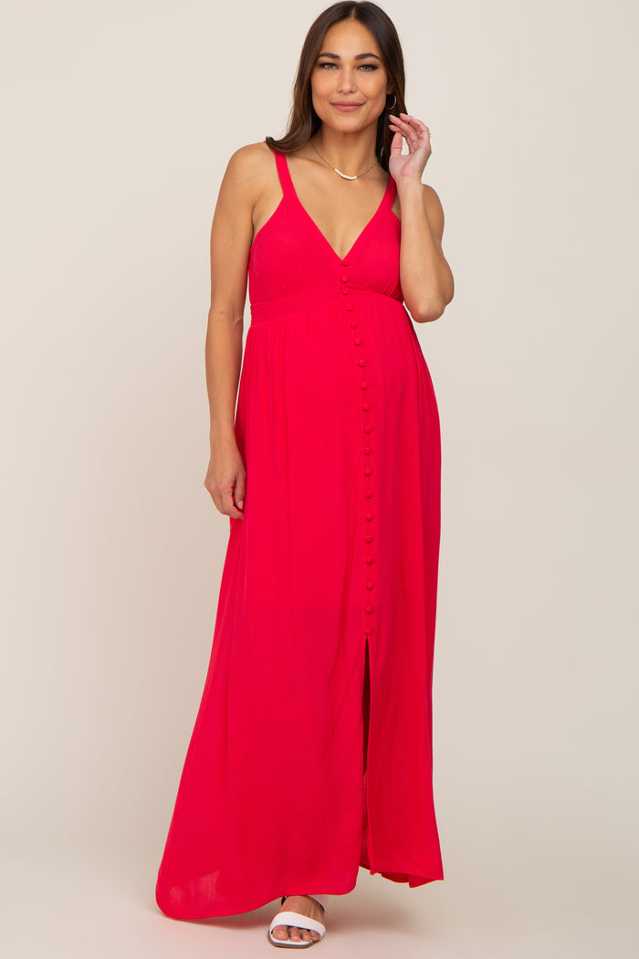 woman wearing a bright pink maternity maxi dress with a v-neckline and button detailing, showing her baby bump