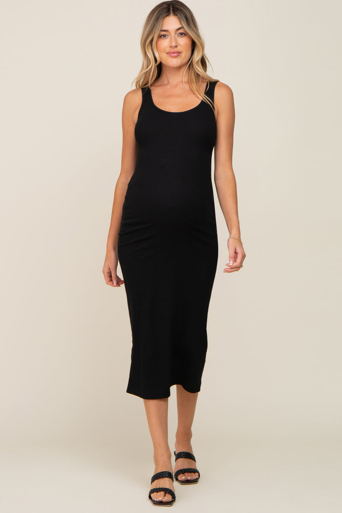 woman wearing a black tank midi maternity dress showing her baby bump