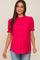 woman wearing a bright pink short sleeve maternity top with ruffle details and a baby bump visible