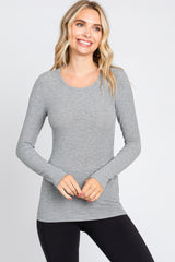woman wearing a grey long sleeve fitted top with a scoop neckline and lightweight fabric