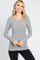 woman wearing a grey long sleeve fitted top with a scoop neckline and lightweight fabric