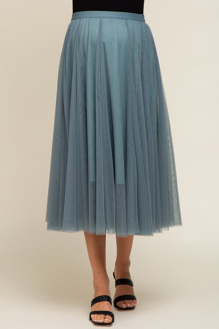 woman wearing a light blue maternity tulle skirt with layered design and a flowy silhouette