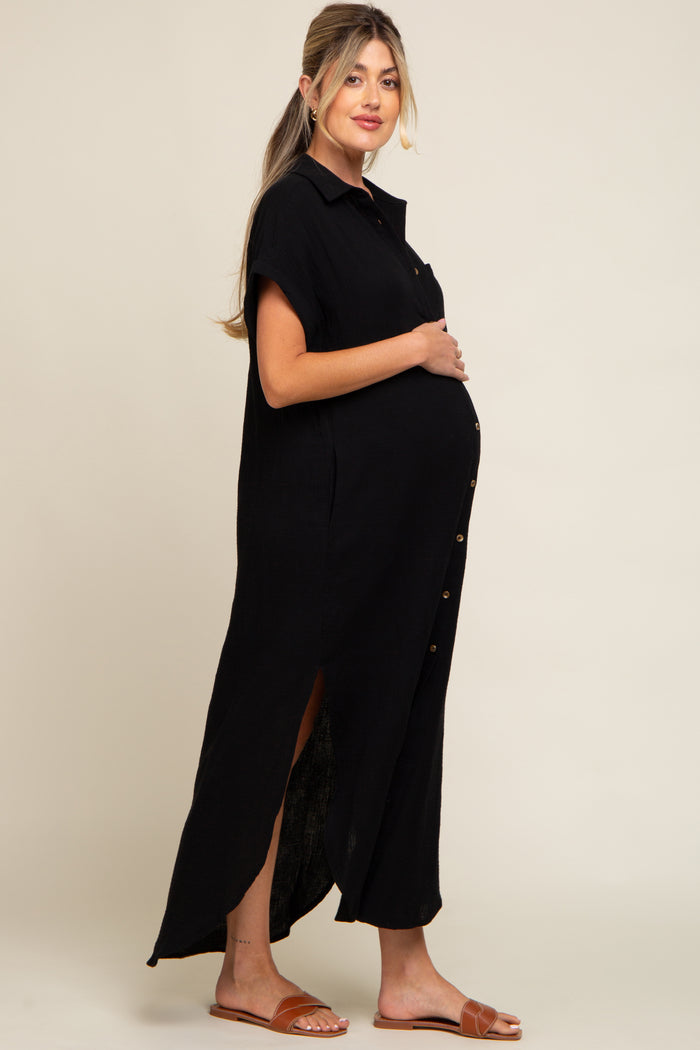 pregnant woman wearing a black short sleeve button down maternity maxi dress with side slits and brown sandals