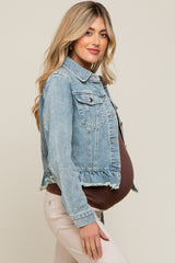 woman wearing a light wash maternity denim jacket over a brown top, showcasing her baby bump