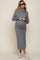 woman wearing a gray maternity hoodie dress with a drawstring and a visible baby bump