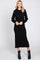 woman wearing a black hooded sweatshirt dress with a fitted silhouette and a drawstring waist, smiling at the camera