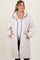 woman wearing a light beige quilted maternity coat with a hood and pockets, baby bump visible